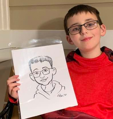 child showing a caricature drawing of himself