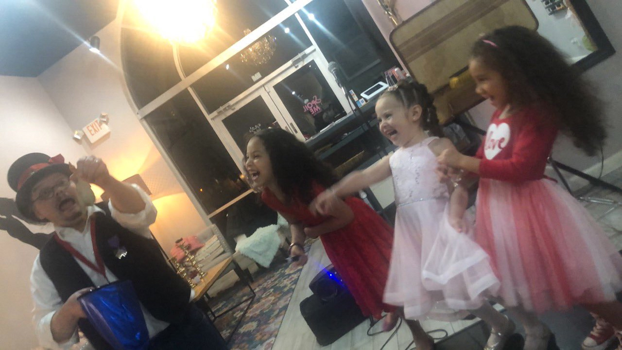 little girls laughing at a magic trick