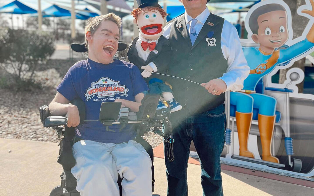 photo of young man in wheelchair with puppet and magician